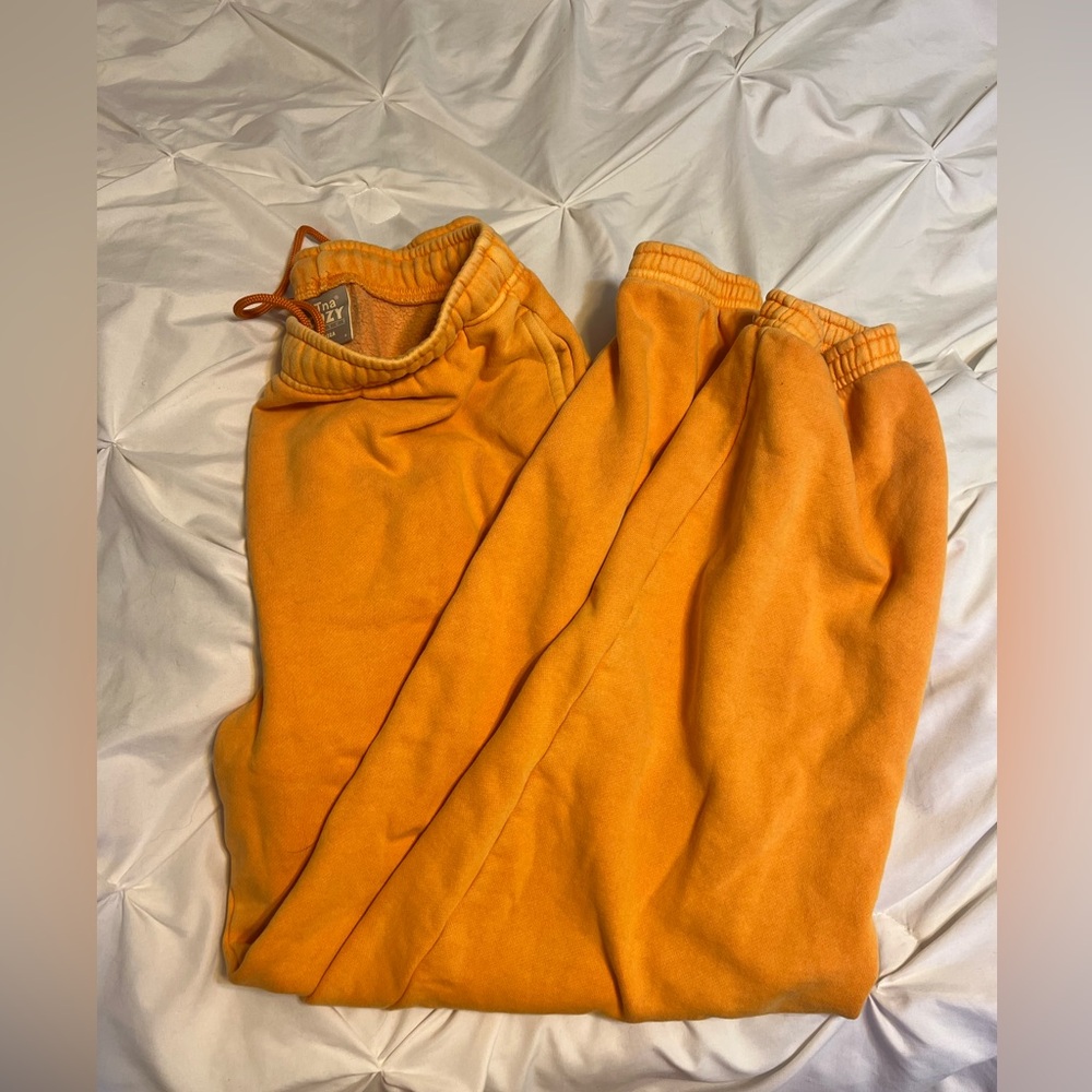 TNA orange mega sweatpants